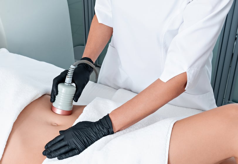 Ultrasound cavitation body contouring treatment. Woman getting anti-cellulite and anti-fat therapy on her leg in beauty salon